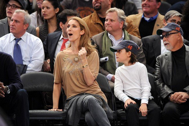 Celine Dion, gray denim jeans, beige blouse, gold watch