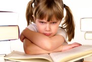 child scowling at homework