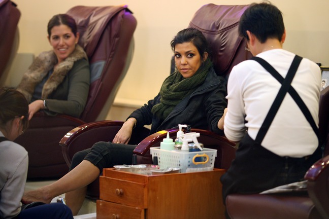 Kourtney Kardashian, black pants, green scarf, pedicure