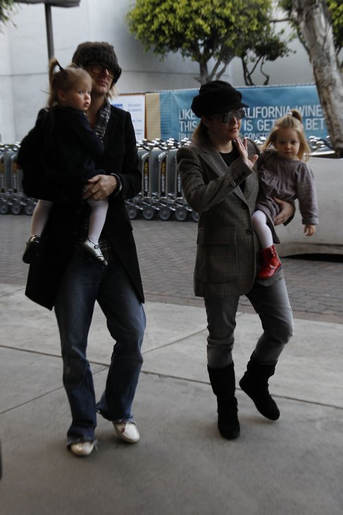 Lisa marie presley, plaid jacket, black hat, sunglasses, twin daughters, black boots