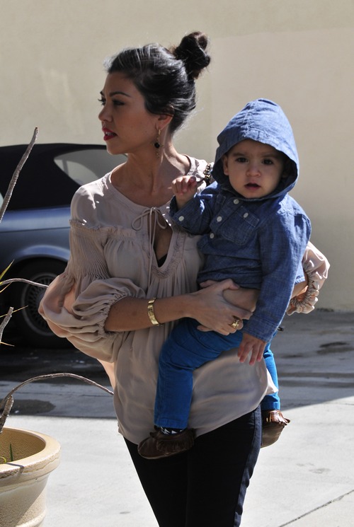 Kourtney kardashian, nude blouse, taupe blouse, black leggings, gold bracelet