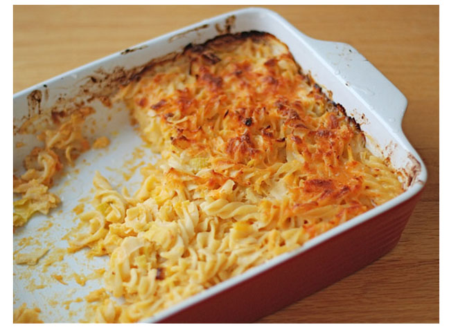 spiral pasta bake in half empty dish