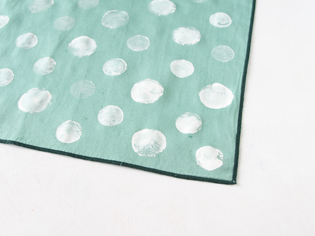 Use plastic bottle caps to stamp napkins.