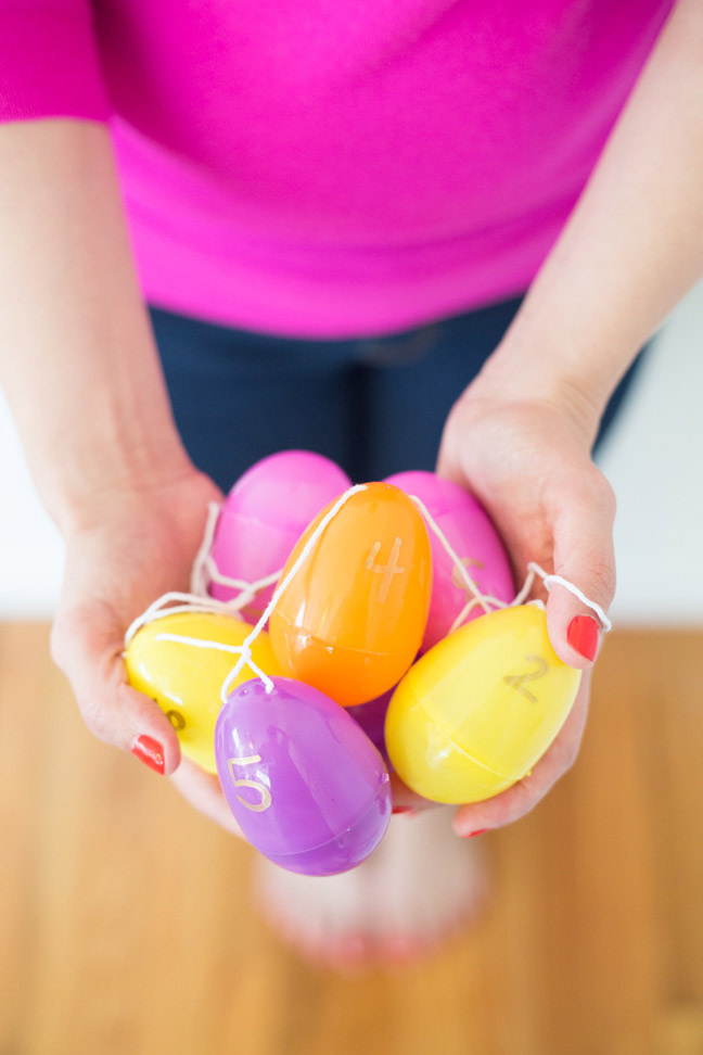 plastic-easter-egg-garland-pink-shirt-hands