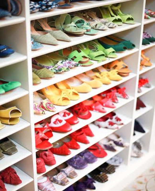 Shoes in closet organized by color