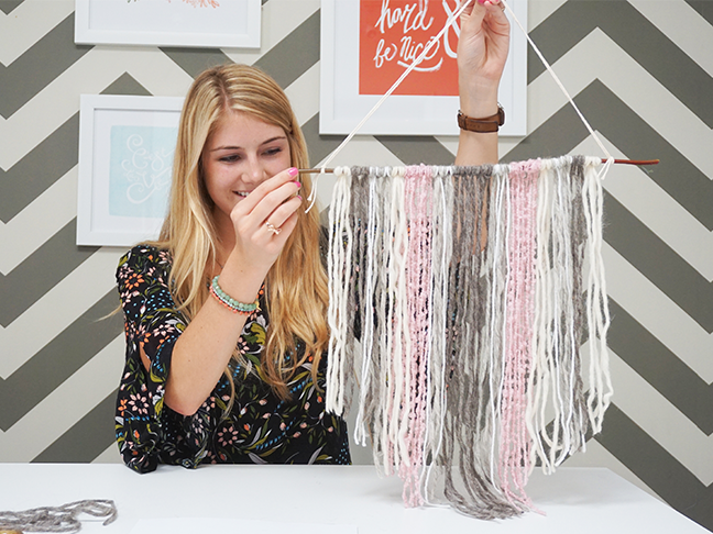 complete pink, grey and white yarn tapestry