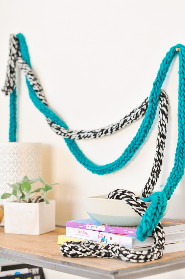 DIY Fingerknit Garlands styled on a wall