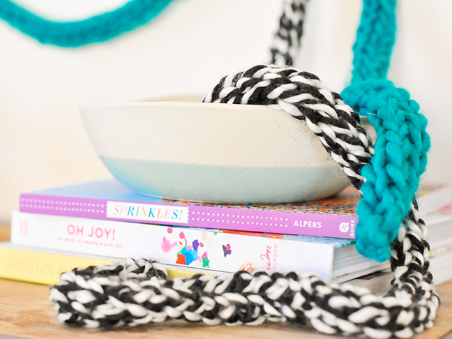 DIY Fingerknit Garlands styled on a wall