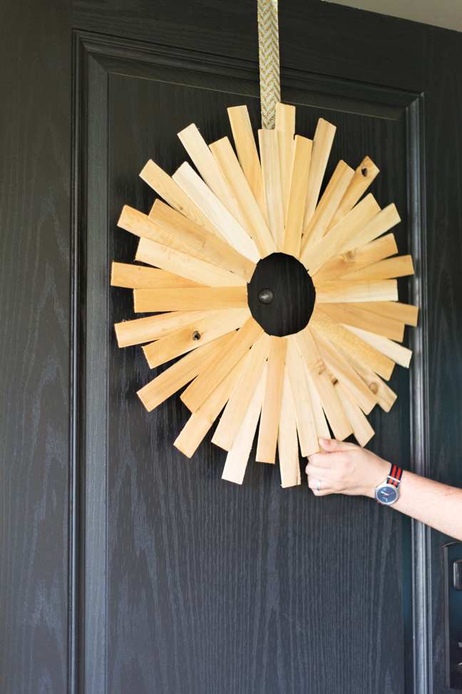 hand-wood-starburst-wreath-on-door