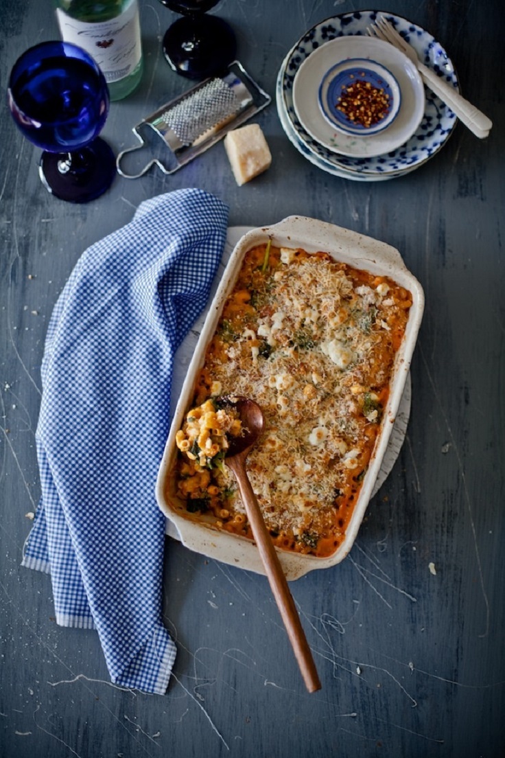 mac and cheese in white ceramic dish with wood spoon