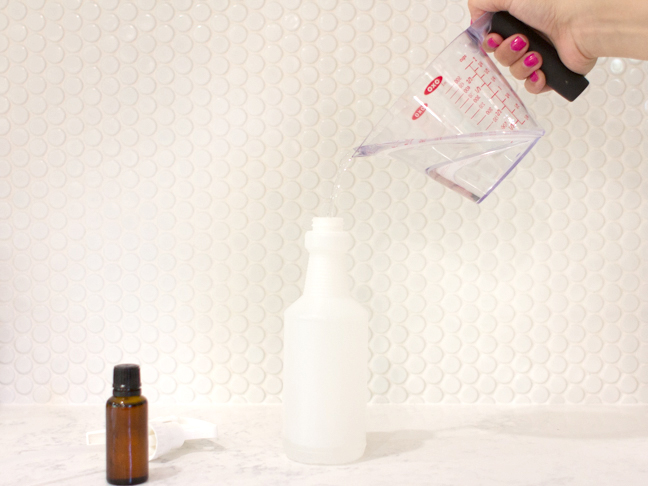 hand-pouring-liquid-into-spray-bottle