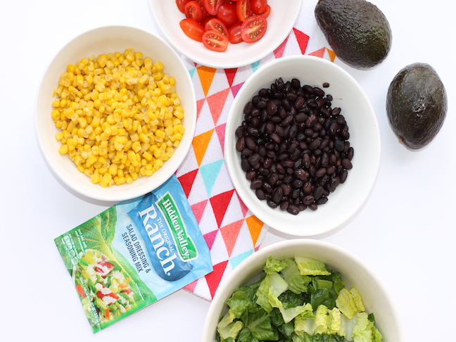 bowls of corn, black beans, tomatoes, lettuce