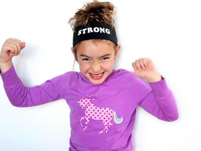 girl in unicorn shirt strong headband