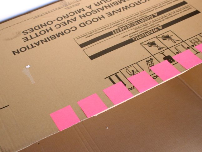 pink-post-it-notes-on-a-cardboard-box