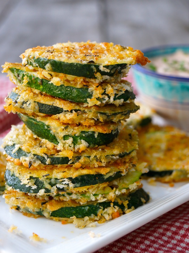 coated zucchini pieces-green-white plate-red cloth-wood table