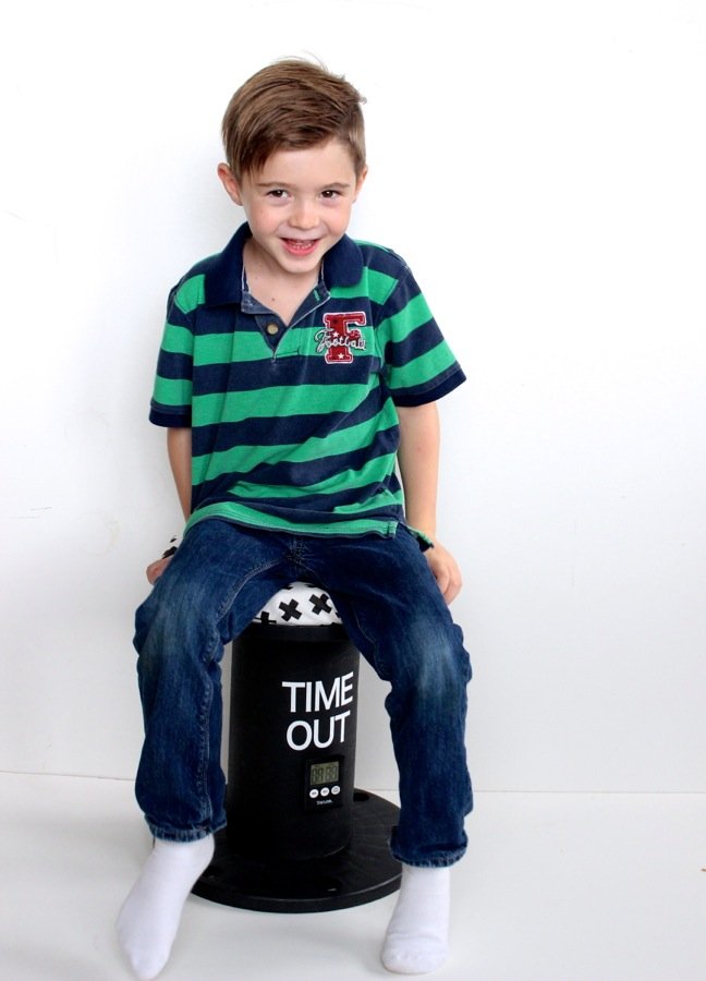 boy-smiling-on-a-time-out-chair