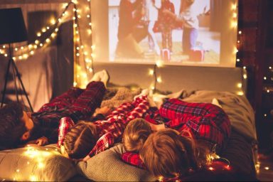 Parents and kids watching Christmas movies together