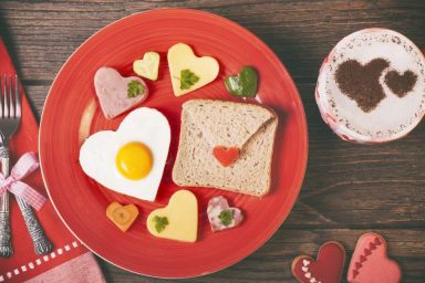 Lunch on Valentine's Day on rustic wooden table.