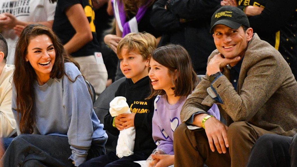 Actors Mila Kunis and Ashton Kutcher and their children look on during the WNBA basketball game between the Indiana Fever and the Los Angeles Sparks on May 24, 2024, at Crypto.com Arena in Los Angeles, CA.