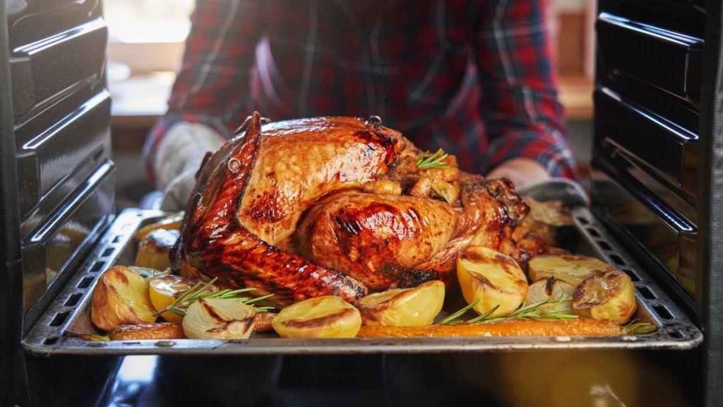 Roasting Turkey in the Oven on a sheet pan for Thanksgiving Dinner.