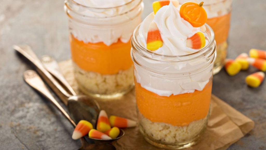 Halloween dessert in a jar layered candy corn parfait with cream cheese