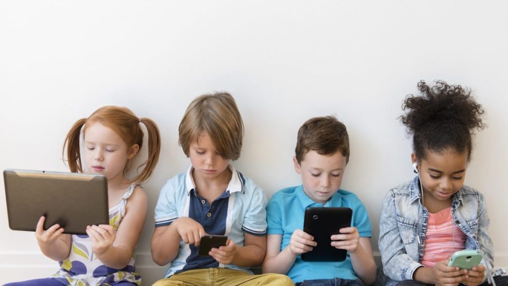 Kids sitting on their gadgets, scrolling through social media, which has now been banned for children under 16 in Australia.