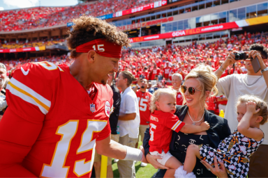 Patrick Mahomes #15 of the Kansas City Chiefs greets his wife, Brittany Mahomes and their two children Patrick Bronze Lavon Mahomes and Sterling Skye Mahomes prior to the game against the Cincinnati Bengals at GEHA Field at Arrowhead Stadium on September 15, 2024 in Kansas City, Missouri.