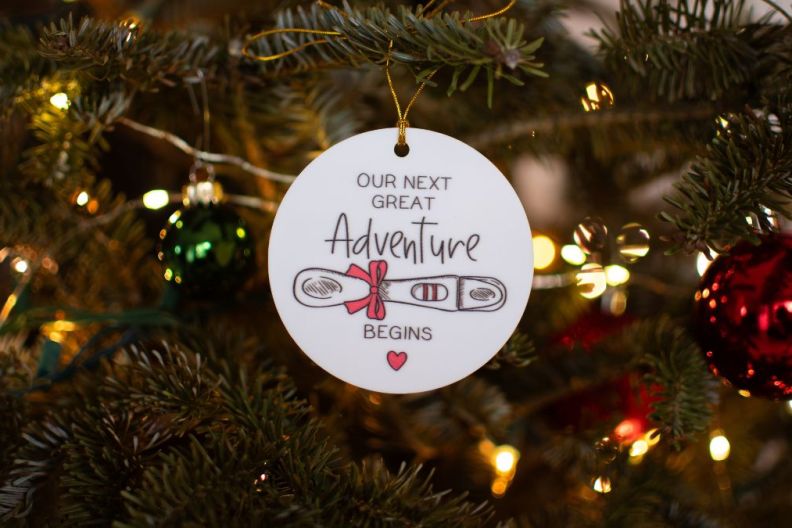 Pregnancy announcement decoration on a Christmas tree. Pregnancy concept. Christmas ornament on a tree pregnancy announcement. Family concept