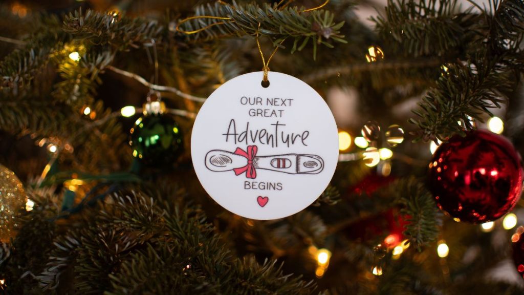 Pregnancy announcement decoration on a Christmas tree. Pregnancy concept. Christmas ornament on a tree pregnancy announcement. Family concept