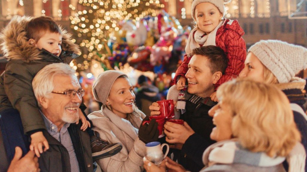 Photo of a cheerful family, celebrating Christmas Holidays on Christmas market