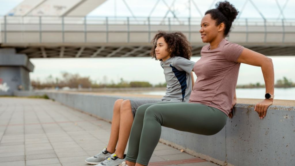 Mother and Her Teenage Son Are Doing Exercise Outside.