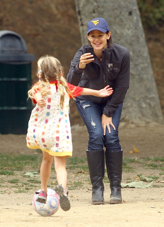 Jennifer Garner, blue baseball hat, braid, black jacket, black boots, holey denim jeans