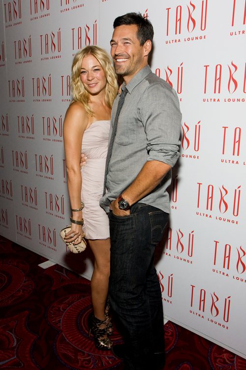 eddie cibrian, gray shirt, red carpet, LeAnn Rimes, dress, clutch purse, beige dress, cream dress